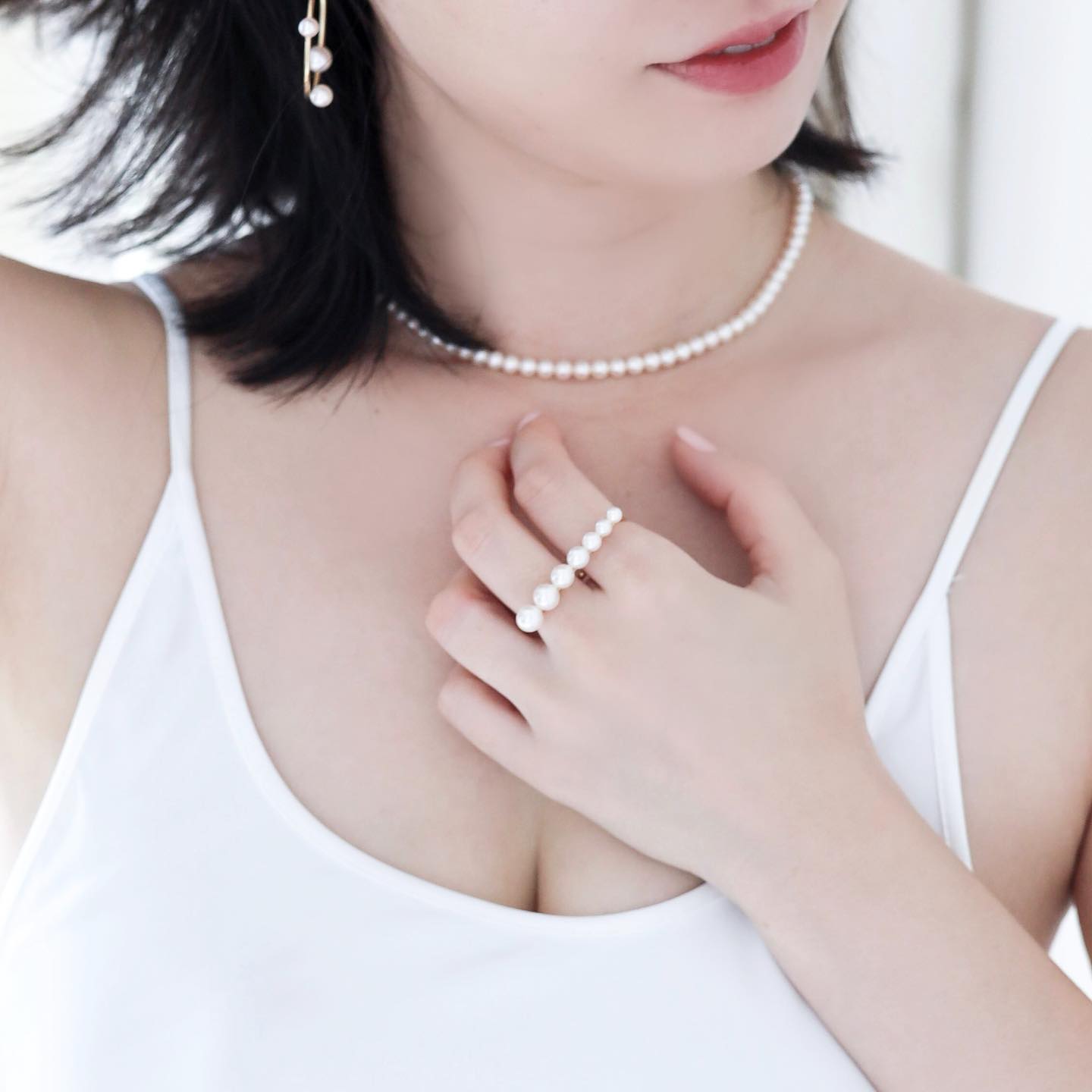 Asian woman wearing Akoya Hoop Earrings paired with Akoya Baby Pearl Classic Necklace and Akoya Pearl Double Finger Ring