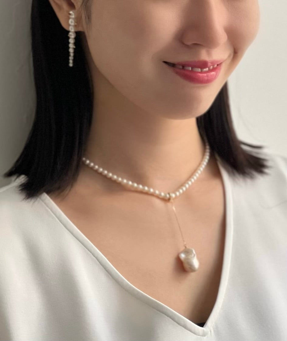 Asian Woman wearing Akoya Gold Studs Earring on ear and Akoya Baby Pearl Classic Necklace with a Baroque Pearl Charm hooked onto the necklace