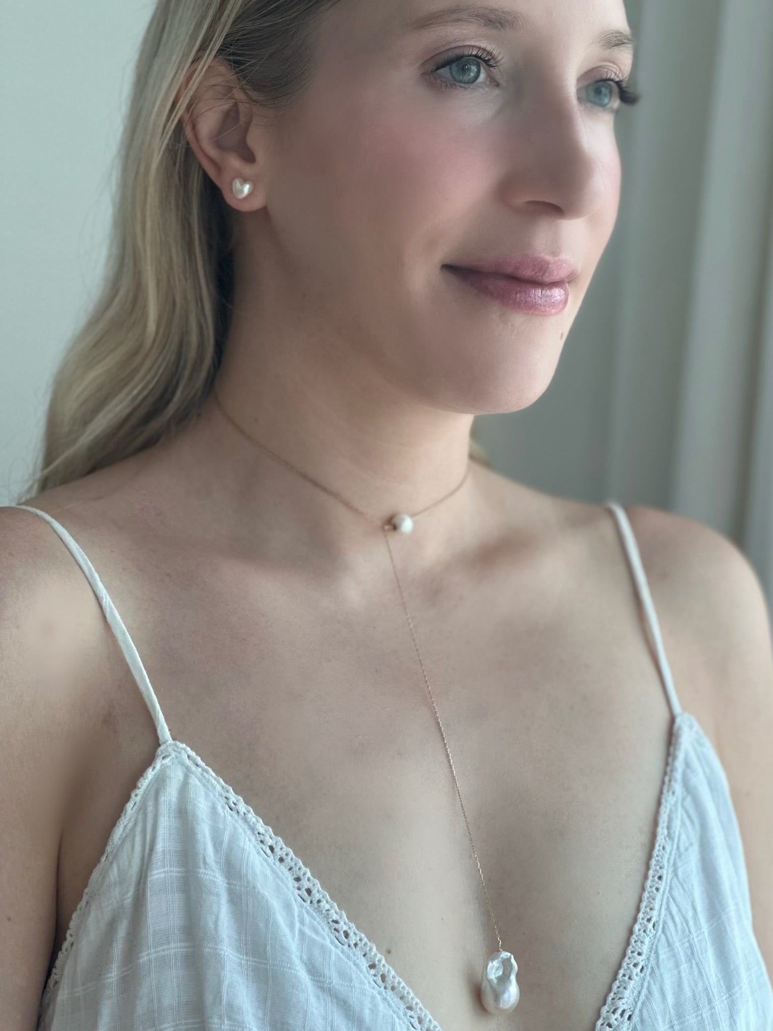 White Woman wearing Akoya Heart Earrings and Baroque Pearl Long Necklace