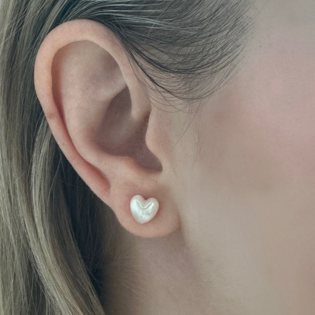 Closeup of Akoya Heart Earrings on ear