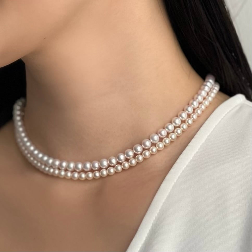 Closeup of 2 Akoya Baby Pearl Classic Necklace on woman's neck