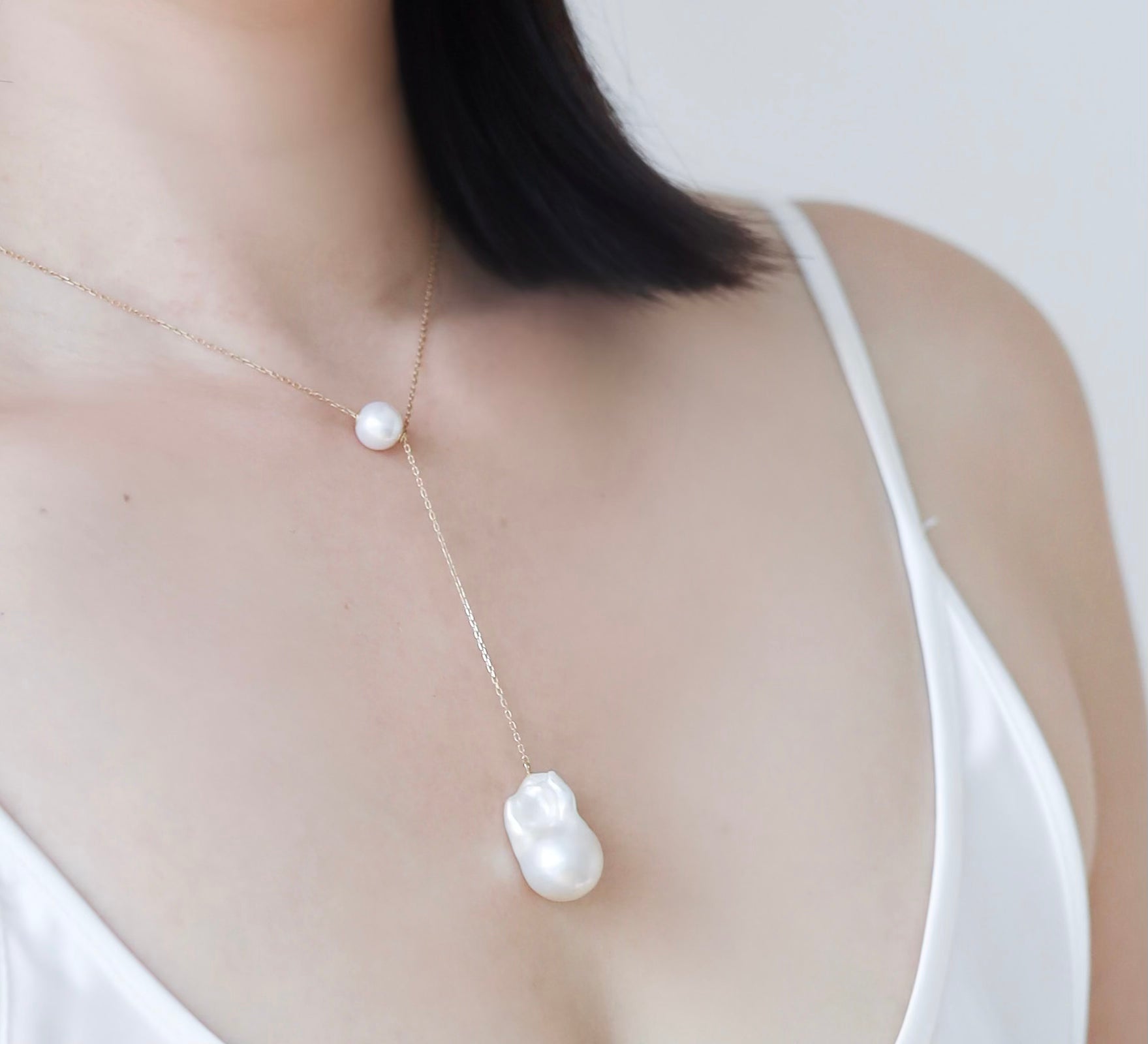 Closeup of Baroque Pearl Long Necklace on woman's chest