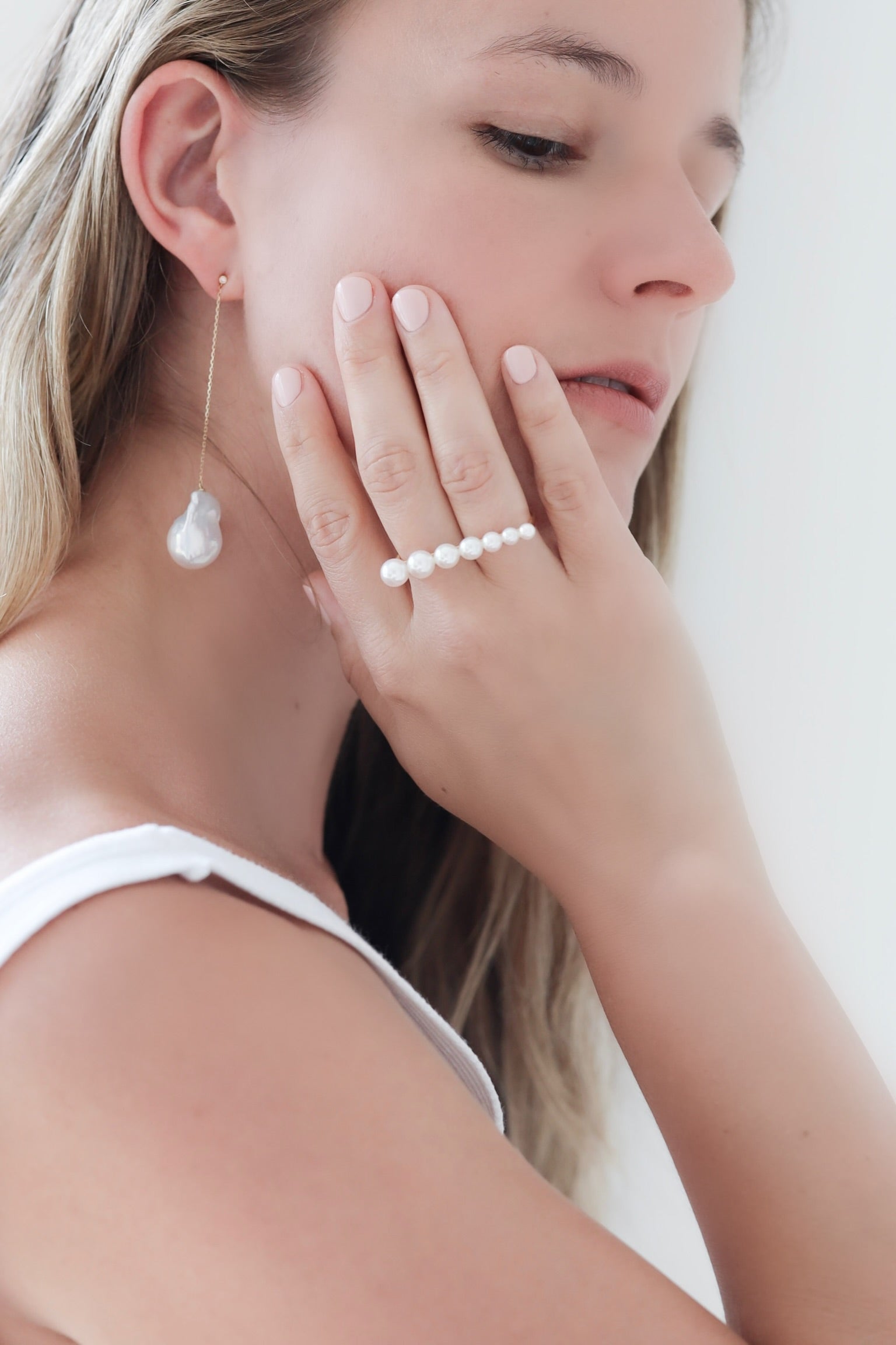 White woman wearing Baroque Pearl Swing Earrings with Akoya Pearl Double Finger Ring