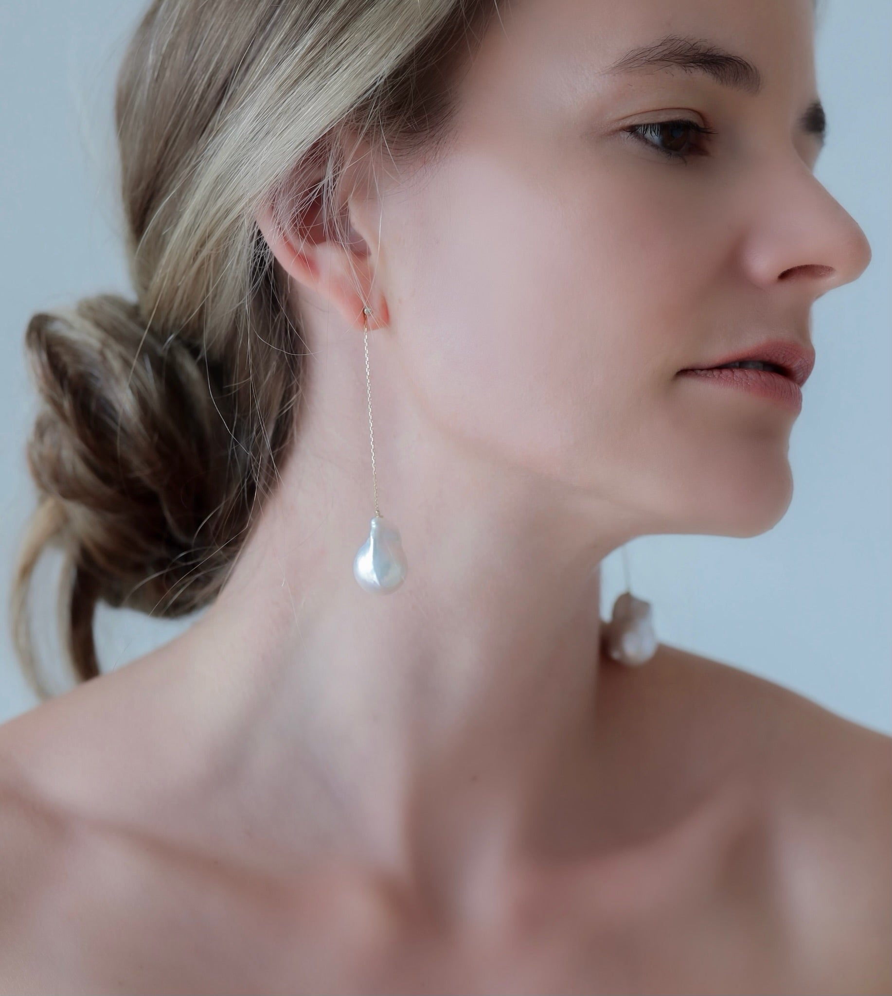 White woman wearing Baroque Pearl Swing Earrings
